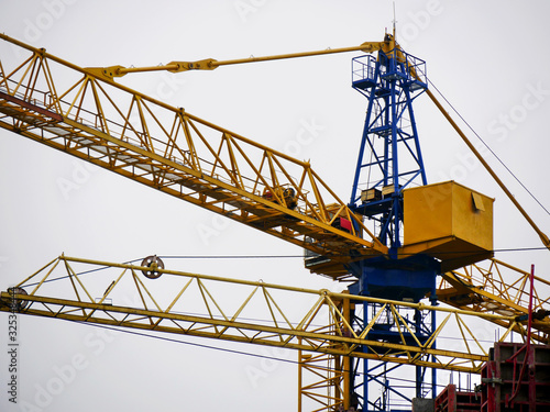 Wallpaper Mural Crane. Self-erection crane near concrete building. Construction site. Torontodigital.ca