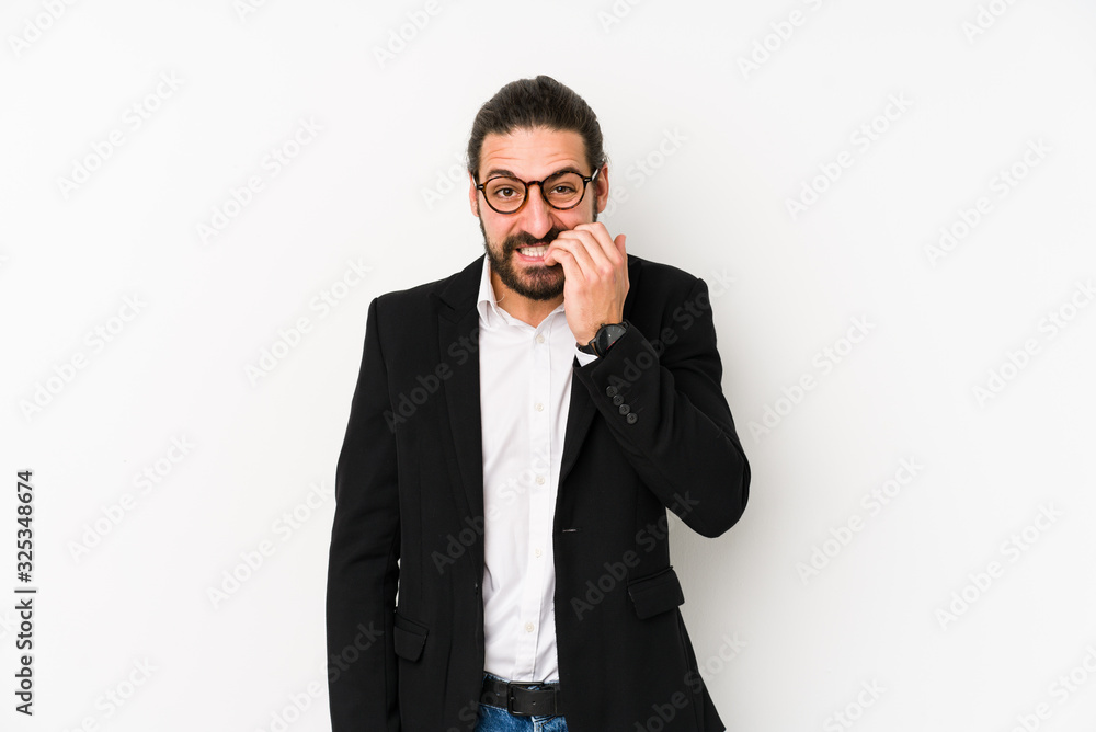 Young caucasian business man isolated on a white background biting fingernails, nervous and very anxious. Young caucasian business man isolated on a white background biting fingernails, nervous and very anxious.