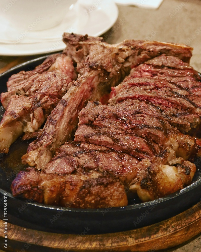 closeup prime rib steak in hot plate