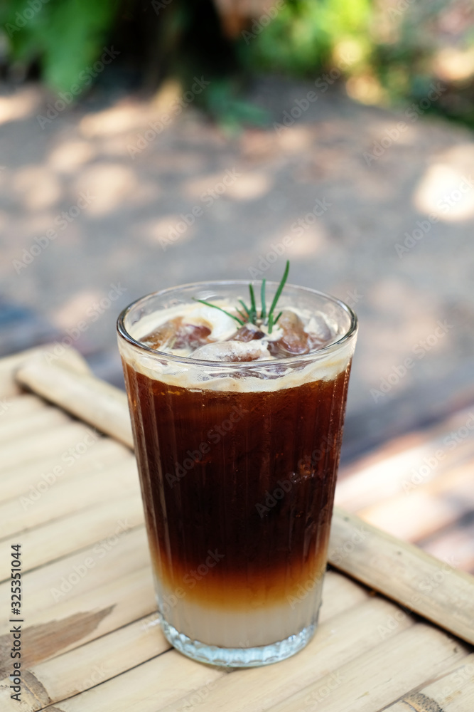 closeup iced americano on bamboo table closeup iced americano on bamboo table