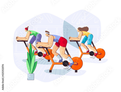 Group of People is Training in Exercise Bikes Stationary Cycling Class in Fitness Club