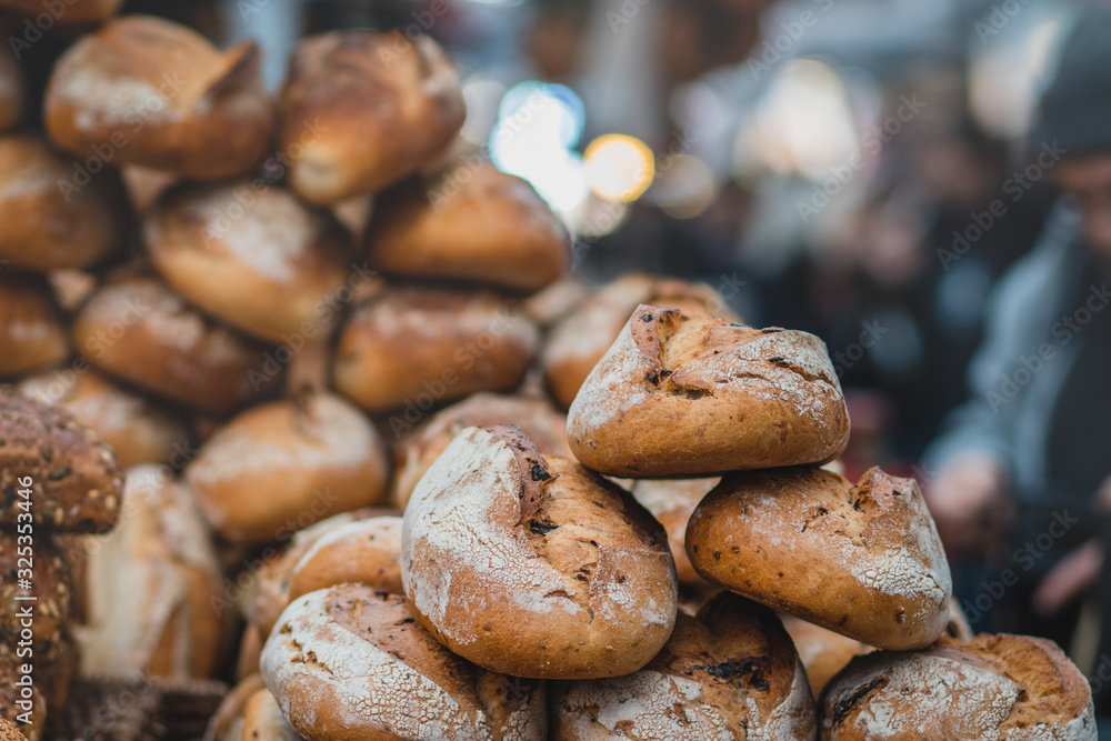 A pile of fresh bread made from whole flour. Crispy, blurred background. The Market, Jerusalem.