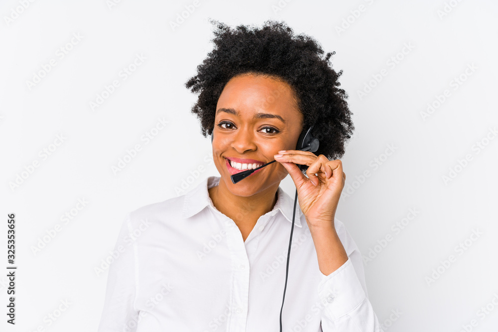 Young african american telemarketer woman isolated showing a mobile phone call gesture with fingers. Young african american telemarketer woman isolated showing a mobile phone call gesture with fingers.