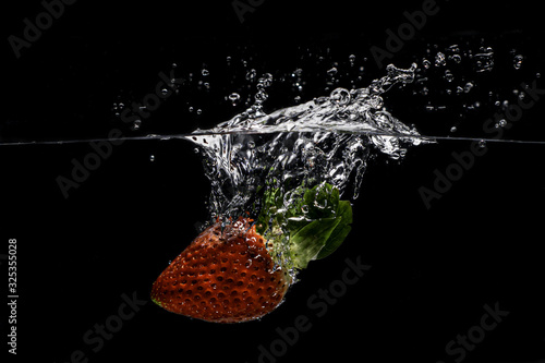  Strawberry splashes into water photo