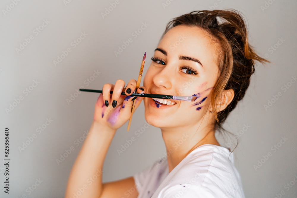 Artist. Designer. Young girl artist paints on a wall indoors. Interior Design. The creative process. Artist. Designer. Young girl artist paints on a wall indoors. Interior Design. The creative process.