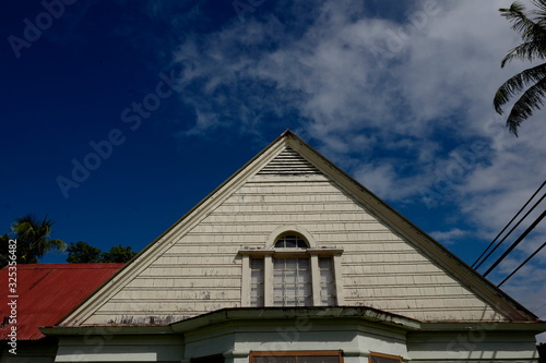 Thatched roof with window on top floor of home