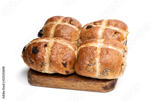 Easter wholemeal hot cross buns on wooden board isolated on white photo