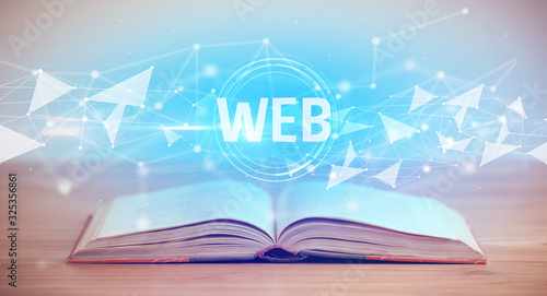 Open book with WEB abbreviation, modern technology concept photo