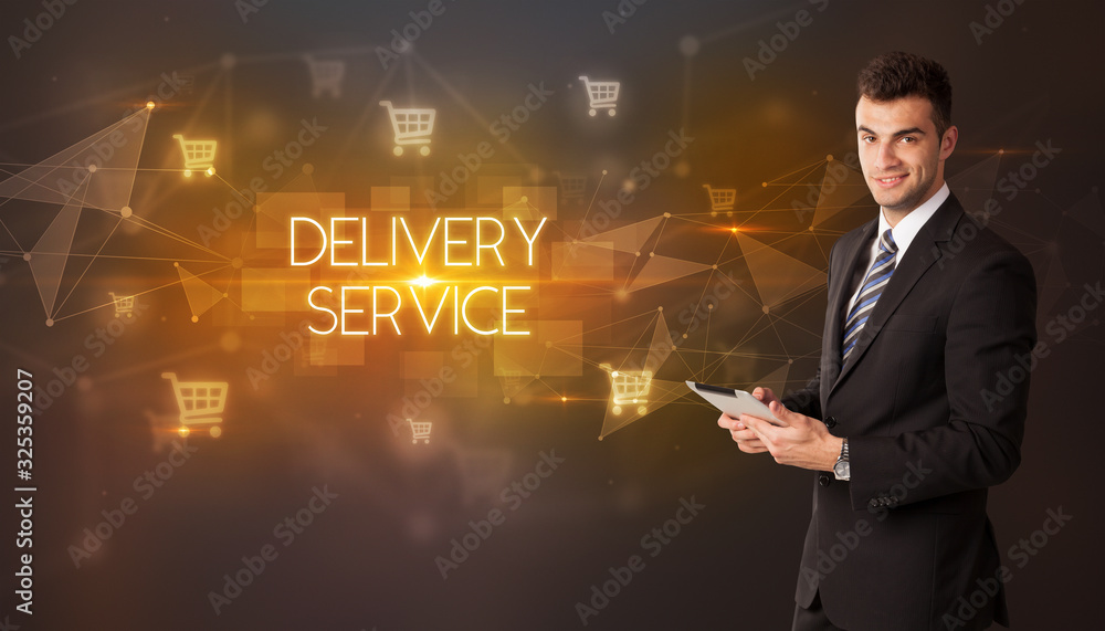 Businessman with shopping cart icons and DELIVERY SERVICE inscription, online shopping concept Businessman with shopping cart icons and DELIVERY SERVICE inscription, online shopping concept