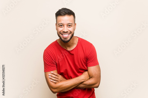Young south-asian man laughing and having fun.