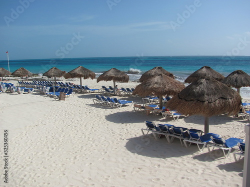 beach with lounge chairs and umbrellas © David