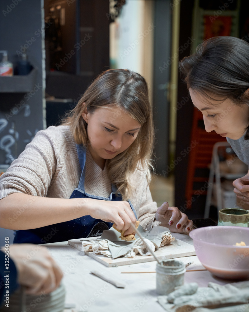 Fototapeta premium Woman making ceramic pottery. Concept for woman in freelance, business.