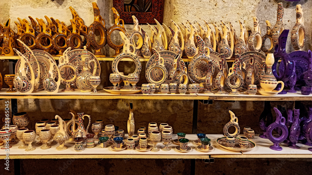 Hittite wine vessels, colorful ceramic vases and porcelain bowls in a underground cave atelier in Avanos in Cappadocia. Turkish traditional ceramic handycrafts in a local pottery shop in Cappadocia
