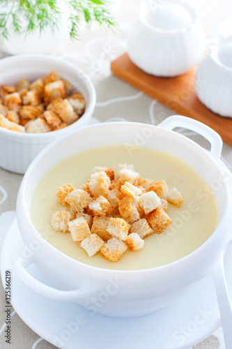 Mashed potato soup with croutons of white bread, selective focus