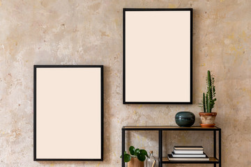 Interior design of living room with two black poster mock up frames, shelf, cacti, plant, books and elegant personal accessoreis. Grunge wall. Stylish home decor. Template. 