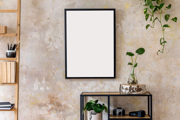 Interior design of living room with black poster mock up frame, shelf, cacti, plant, books, photo camera, wooden ladder and elegant personal accessoreis. Grunge wall. Stylish home decor. Template. 