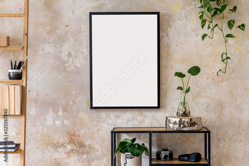 Interior design of living room with black poster mock up frame, shelf, cacti, plant, books, photo camera, wooden ladder and elegant personal accessoreis. Grunge wall. Stylish home decor. Template. 