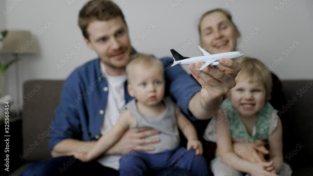 young happy family with children ready for their next trip by plane young happy family with children ready for their next trip by plane