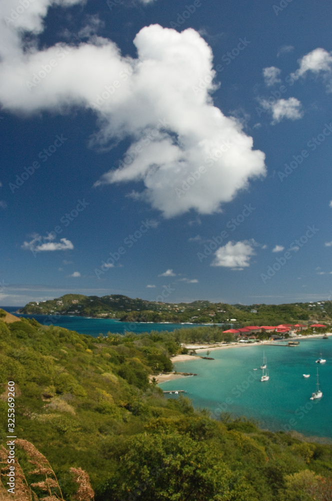 Landscape view from altitude of Pigeon Island, St. Lucia with azure sky and waters dotted with sailboats Landscape view from altitude of Pigeon Island, St. Lucia with azure sky and waters dotted with sailboats