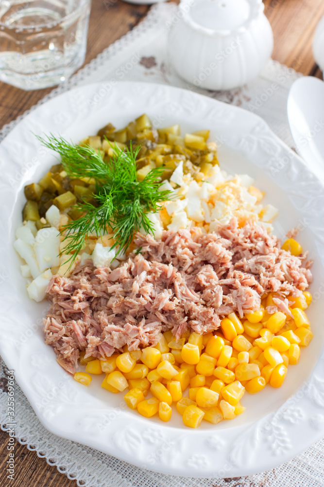 Homemade salad with canned tuna and corn, selective focus Homemade salad with canned tuna and corn, selective focus