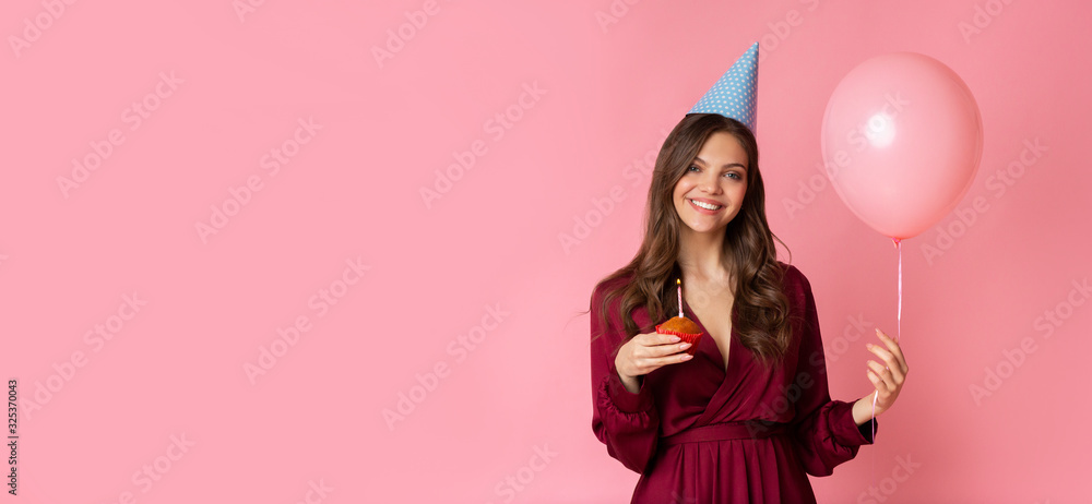 Portrait Of Happy Young Girl Celebrating Birthday With Cupcake And Balloon
