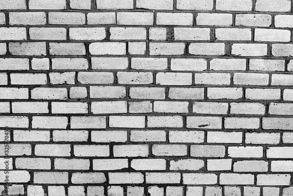 Texture of a brick wall with cracks and scratches which can be used as a background