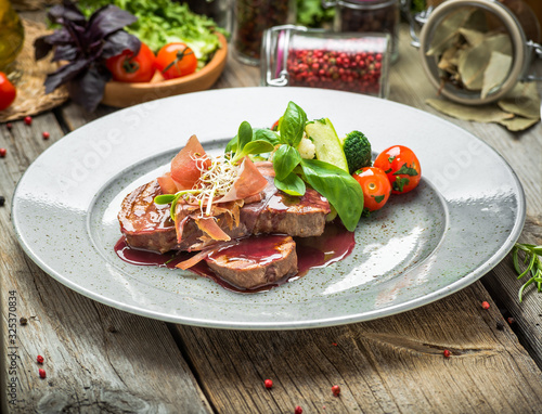 Medallions of veal, with sauce on a plate. photo