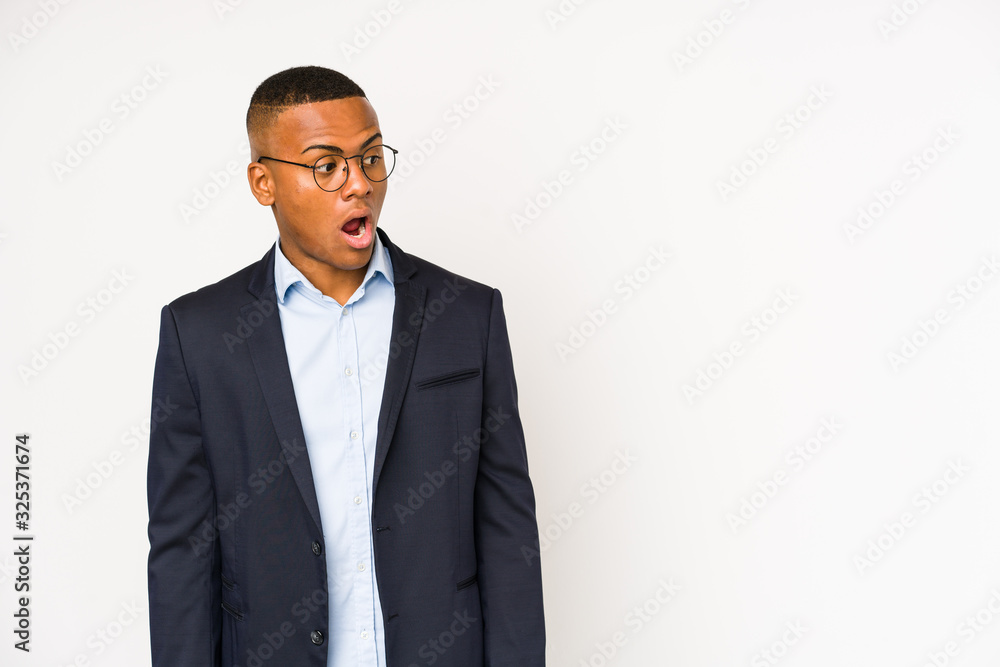 Young business latin man isolated on white background being shocked because of something she has seen. Young business latin man isolated on white background being shocked because of something she has seen.