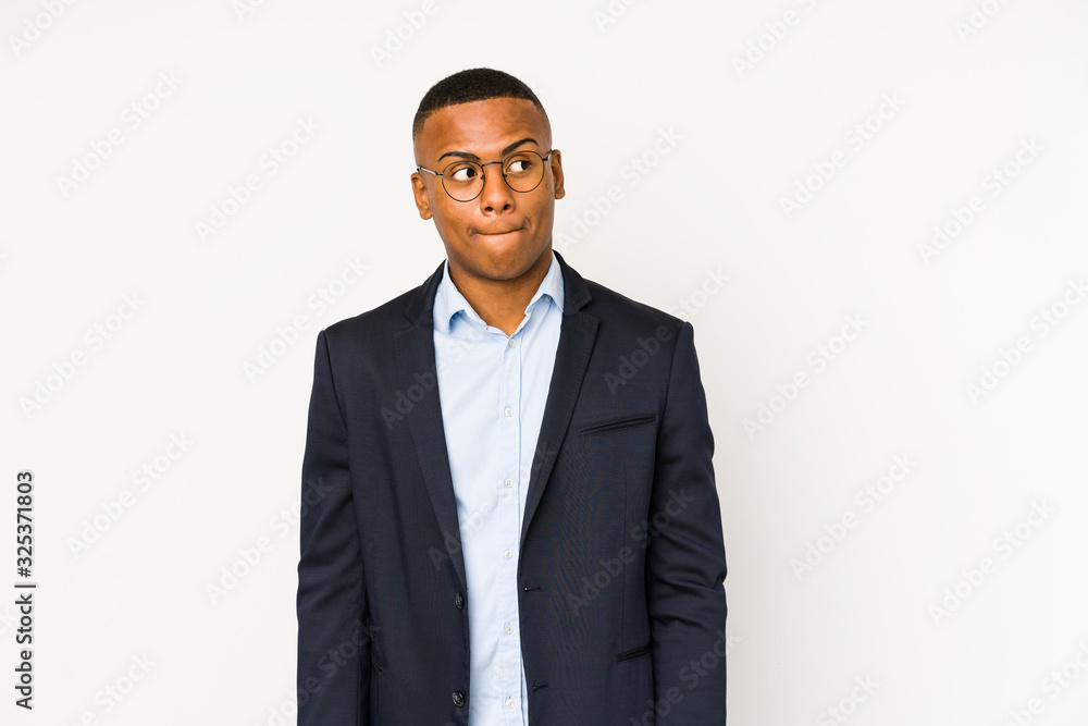 Young business latin man isolated on white background confused, feels doubtful and unsure. Young business latin man isolated on white background confused, feels doubtful and unsure.