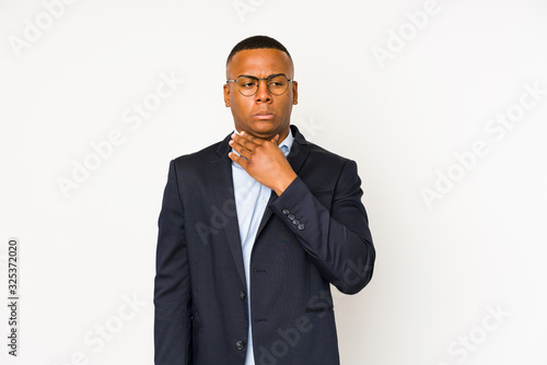 Young business latin man isolated on white background suffers pain in throat due a virus or infection.