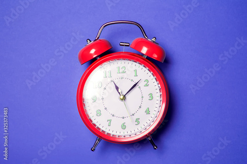 Alarm clock on the color background.