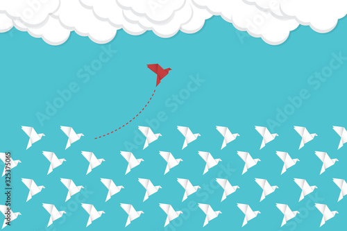 Think differently concept. Be different. Red bird changing direction. New idea, change, trend, courage, creative solution, innovation and unique way concept.	