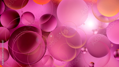 bright oily drops in water with colorful background, close-up 