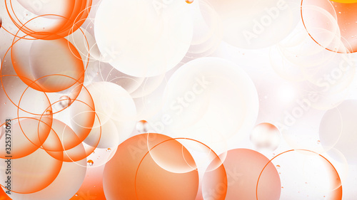 bright oily drops in water with colorful background, close-up
