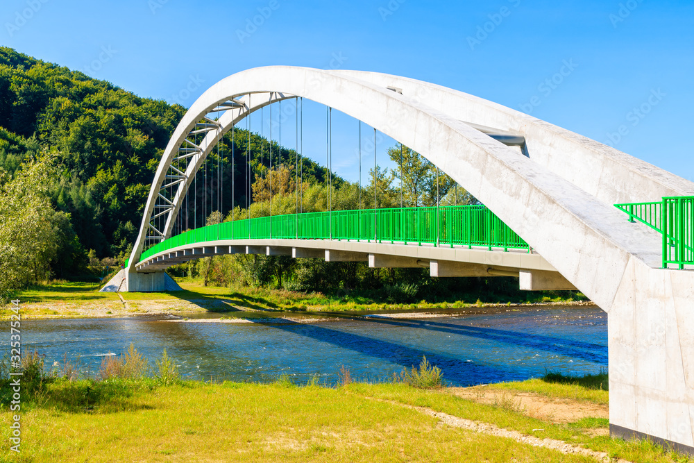 Obraz premium Bridge over Dunajec river and Velo cycling road, Beskid Sadecki Mountains, Poland