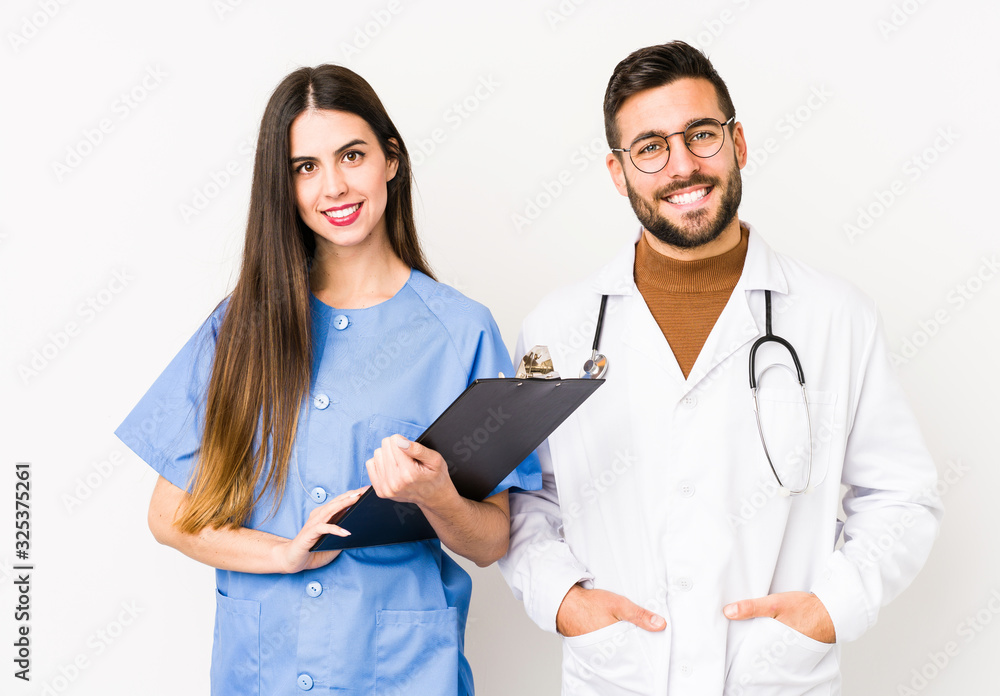 Young doctor man and a nurse isolated happy, smiling and cheerful. Young doctor man and a nurse isolated happy, smiling and cheerful.