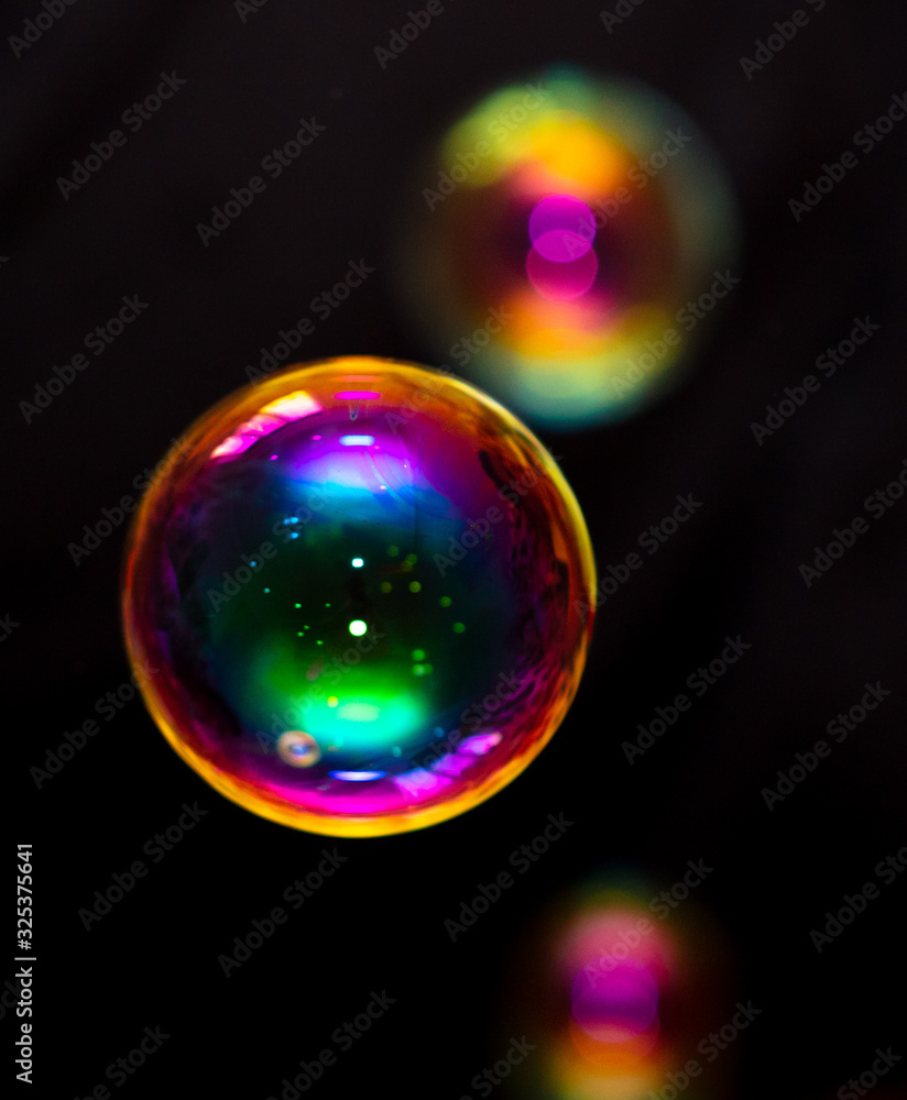 Multicolored soap bubble isolated on a black Multicolored soap bubble isolated on a black