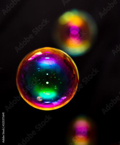 Multicolored soap bubble isolated on a black