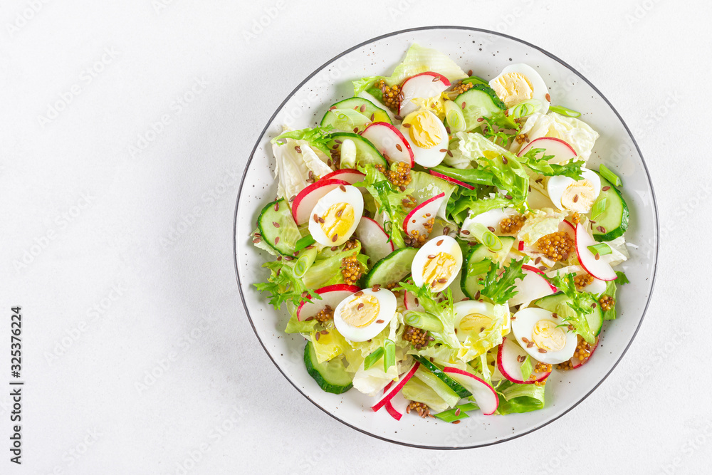 Fresh vegetable salad with cucumber, radish, lettuce and boiled eggs. Helathy food. Top view. Flat lay Fresh vegetable salad with cucumber, radish, lettuce and boiled eggs. Helathy food. Top view. Flat lay
