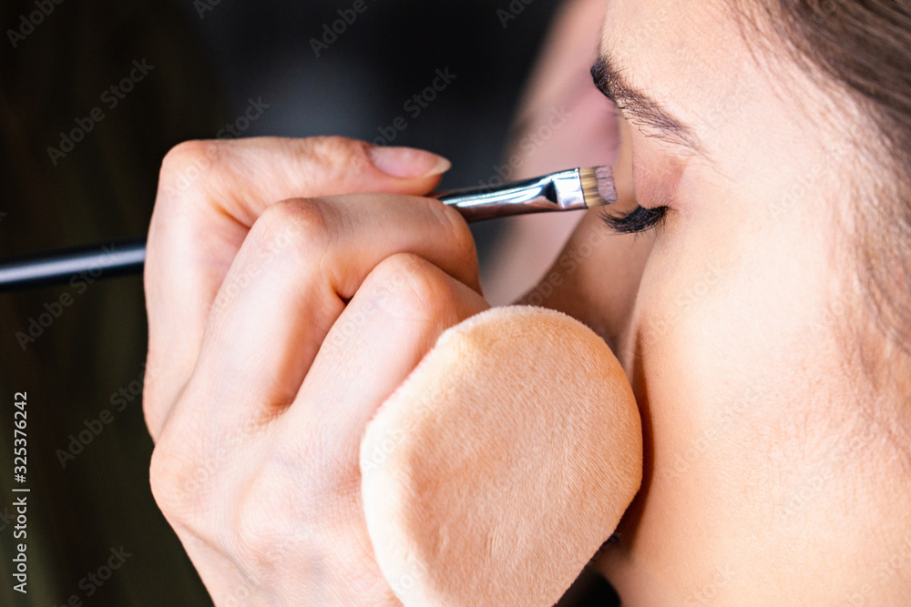 Stylist makes a woman a make-up Stylist makes a woman a make-up