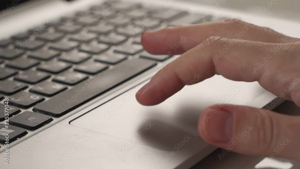 Close up shot of man scrolling a Website Using Laptop Track Pad Close up shot of man scrolling a Website Using Laptop Track Pad