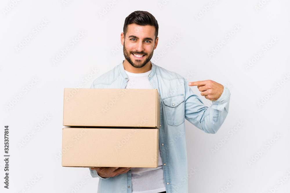 Young caucasian man moving to a new home isolated person pointing by hand to a shirt copy space, proud and confident Young caucasian man moving to a new home isolated person pointing by hand to a shirt copy space, proud and confident
