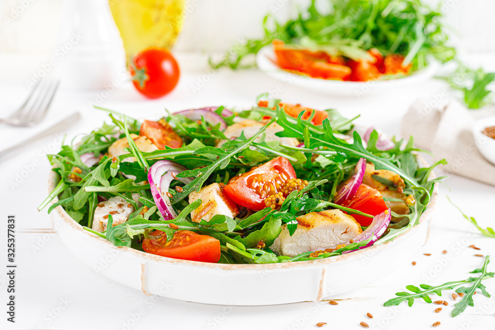 Fresh vegetable salad with grilled chicken fillet, breast, tomato and arugula