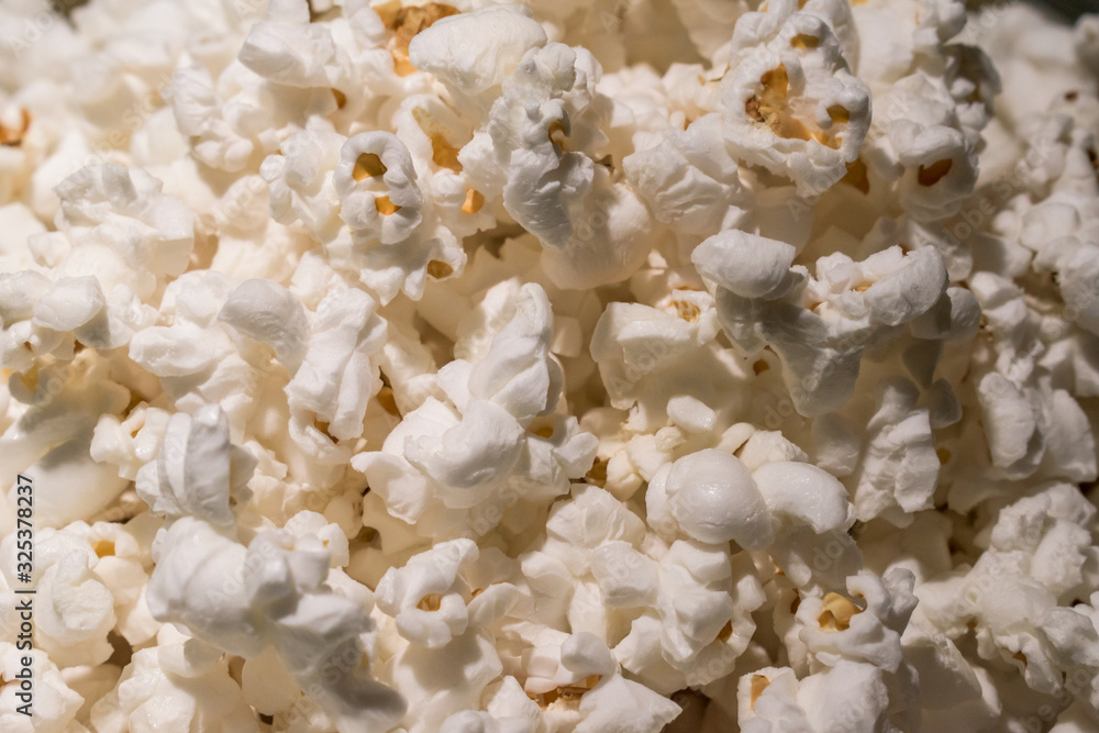 Close up of fresh popcorn with butter under warm lights