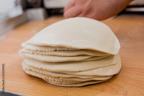 Chef preparing dough for pastry, dumplings, italian pasta or japanese wontons. 
