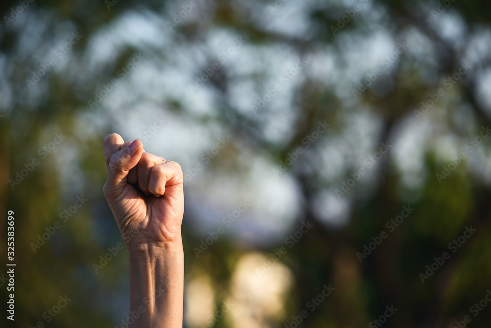 Hand up fist of female in garden green nature background for,teamwork concept. Hand up fist of female in garden green nature background for,teamwork concept.