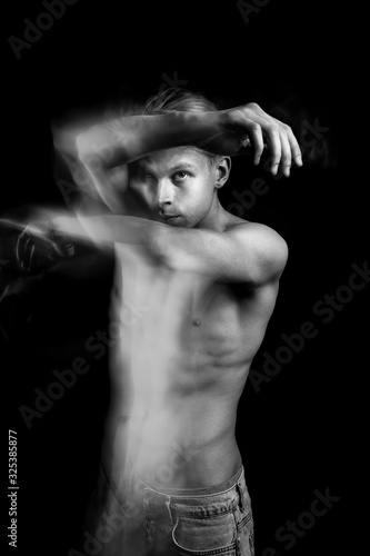 Artistic Dramatic emotional creative portrait of a handsome young naked guy. figurative expression of emotions and feelings. Long exposure creative moody creepy art works. Dancer or fighter