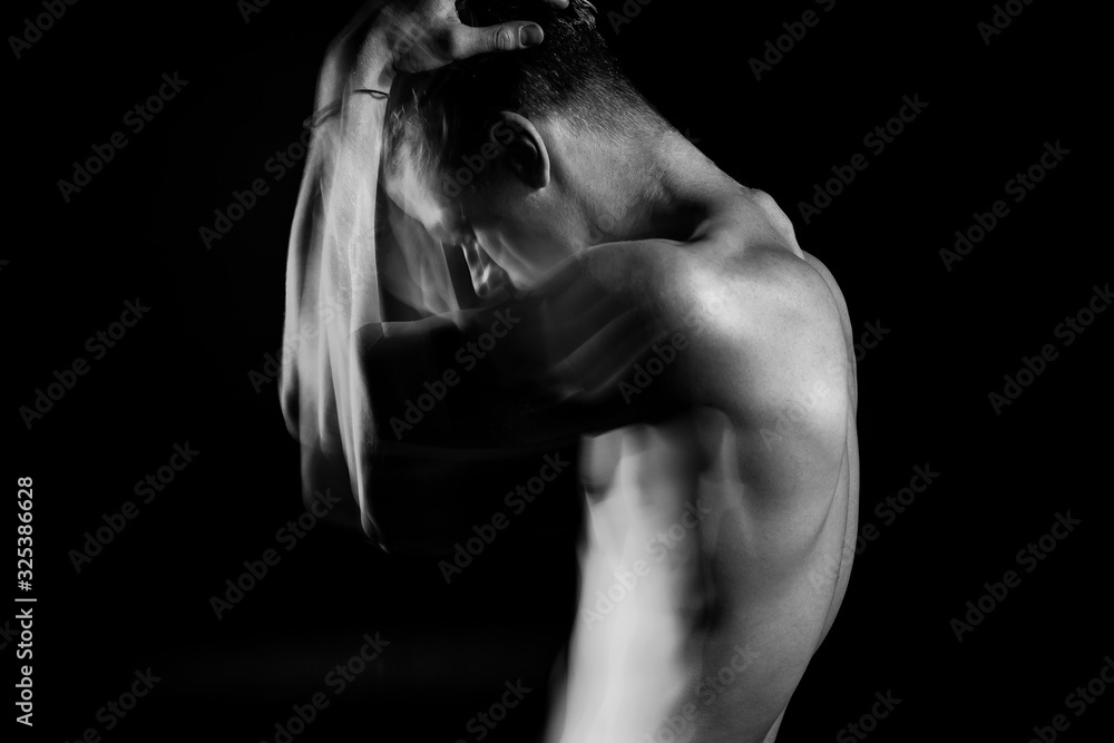 struggling with doubt and suffering. Man holding his head with hands. Profile of young naked guy. Black and white long exposure creative portrait. sports lateral muscles of the chest Original artistic