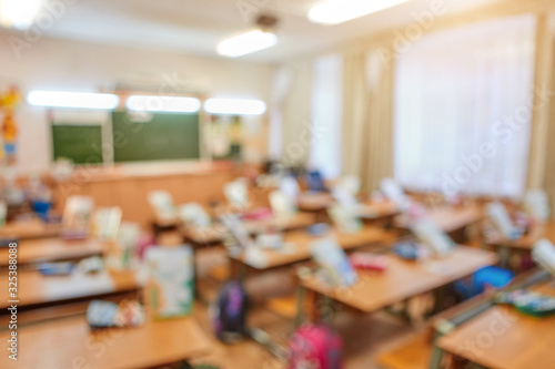 Classroom in a blurred background with no children. Students left their backpacks and notebooks and went on a break.