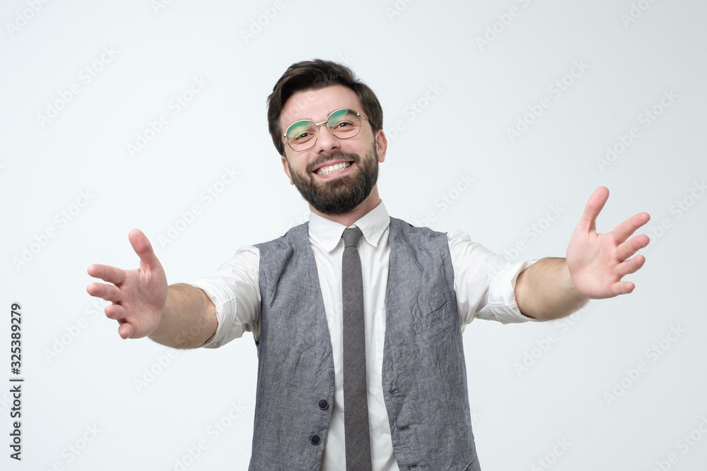 hispanic male wanting to cuddle, smiling broadly, welcoming coworker. hispanic male wanting to cuddle, smiling broadly, welcoming coworker.